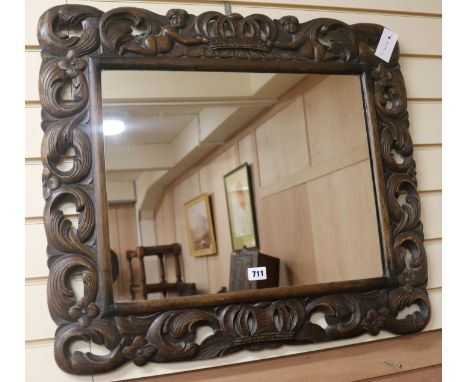 A Carolean style oak framed mirror, W.72cm
