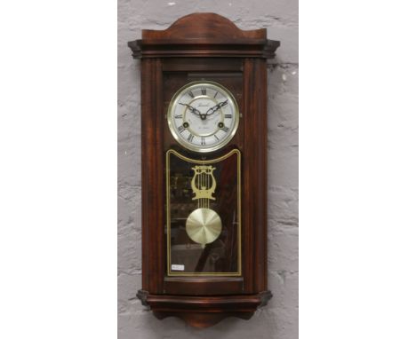 A mahogany cased Lincoln 31 day wall clock chiming on a coiled gong with pendulum and key.