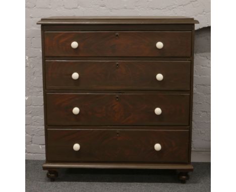 Victorian painted pine chest of four drawers, raised on squat bun feet and having later ceramic drawer pulls, H 128.5cm x W 1