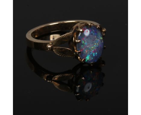 A vintage 9ct gold opal triplet dress ring set on split foliate formed shoulders, size M.