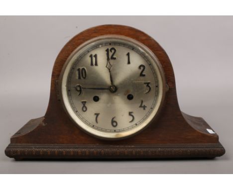 A mid 20th century oak cased dome top 8 day mantle clock with applied Arabic numeral markers with key no pendulum.