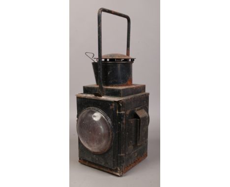 A large vintage painted metal railway signalling lamp.