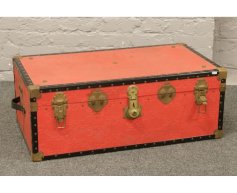A vintage red steamer trunk.
