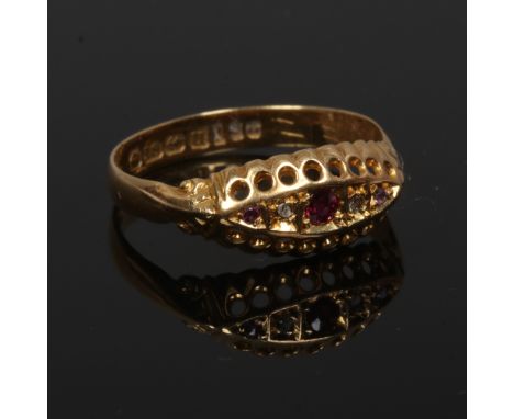 An 18ct gold ruby and diamond ring in boat shaped setting, assayed Birmingham 1919, size O 1/2, 1.9 grams.