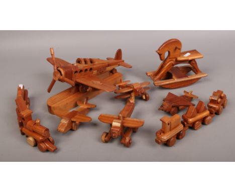 A collection of carved hardwood miniature toys, ornaments, rocking horse, four models of aircraft's, pull along train, along 