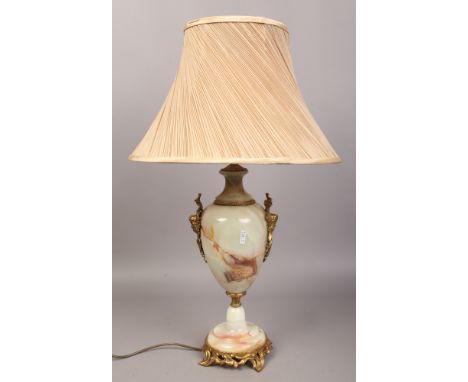 A brass and onyx table lamp of baluster form with ivory silk shade.