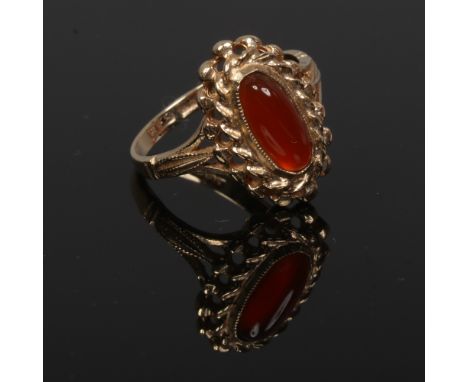 A 9ct gold dress ring set with carnelian on split shoulders, size L.