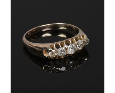 A gold and five stone diamond ring, set with old European cut stones in a boat shaped setting, hallmarks not visible, size O.