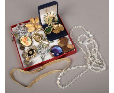 A small tray of vintage costume jewellery including crystal beads, enamel gilt brooches etc.