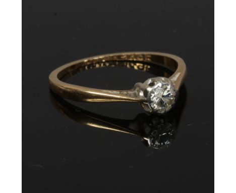 A 9ct gold and platinum solitaire diamond engagement ring. Set with a brilliant cut diamond approximately 0.2ct, size L