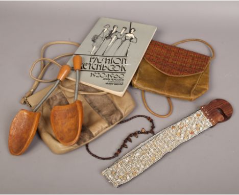 A small collection of fashion accessories to include fashion sketch book, two leather hand bags, beaded belt, beads and shoe 