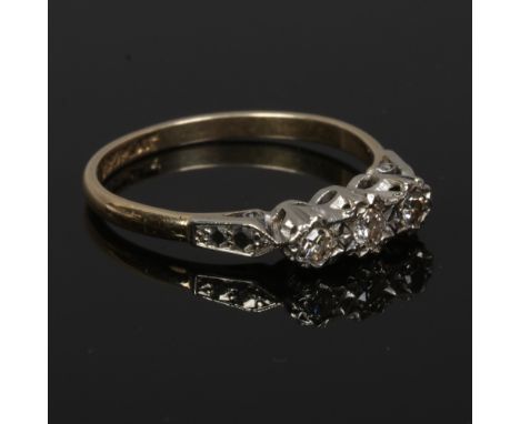 An 18ct gold and platinum three stone diamond ring, size N.