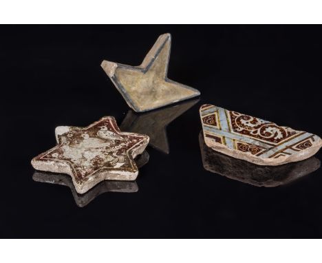 A lot composed of three Islamic star tile fragmentsIran, 12th - 14th century . . Cm 12,00.