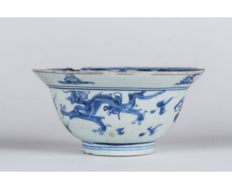 A blue and white porcelain bowl painted with dragons chasing the flaming pearl and bearing a ding incense burner mark at the 