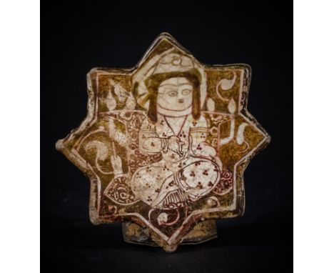 A Kashan lustreware star shaped tileIran, Kashan, 12th - early 13th century . . Cm 14,00 x 14,00. Fritware tile, in the shape