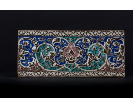 A Qajar border tile Persia, Qajar dynasty, 19th century . . Cm 33,50 x 15,00.