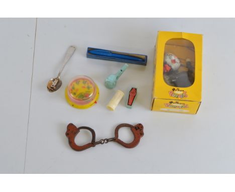 A collection of mod 20th century toys, including a Pelham Puppet, miniature golf game, toy handcuffs, together with some tric
