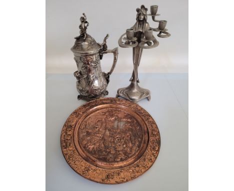 A heavy white metal Art Nouveau style tankard, together with an Art Nouveau candelabra and a German 19th century copper embos