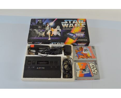 An Atari 2600 Console, together with Spider-man and The Empire Strikes Back games and a Star Wars Parker Interactive Video Bo