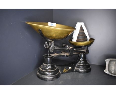 A set of cast and brass kitchen scales with weight set