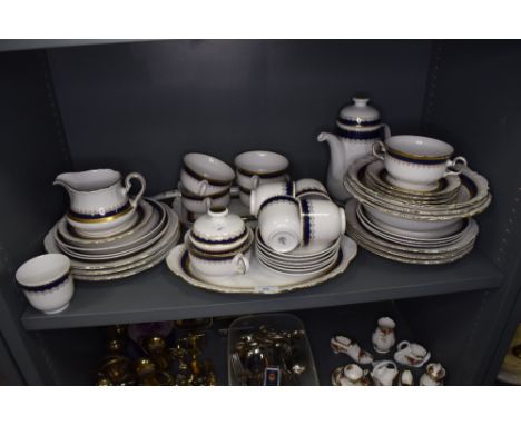 A part tea and dinner service in porcelain by Winterling having blue and gilt design