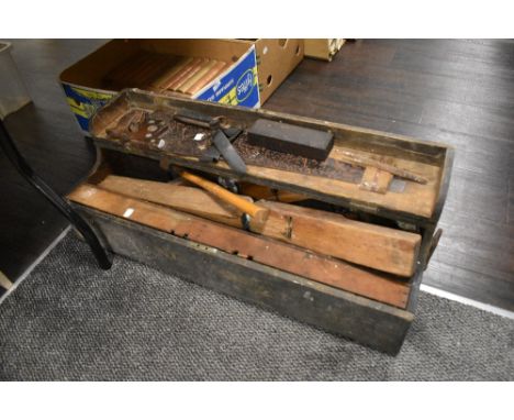 An early 20th century carpenters chest containing a selection of predominantly similarly aged tools including planes, set squ