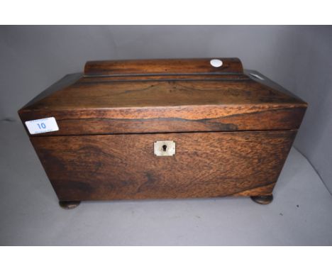 A mahogany cased tea caddy having fitted compartmental inner