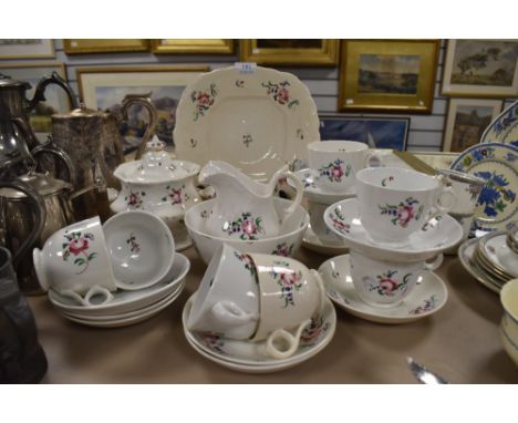 A mid 19th century partial tea service including cups and saucers, jug, basin and more, possibly Minton.