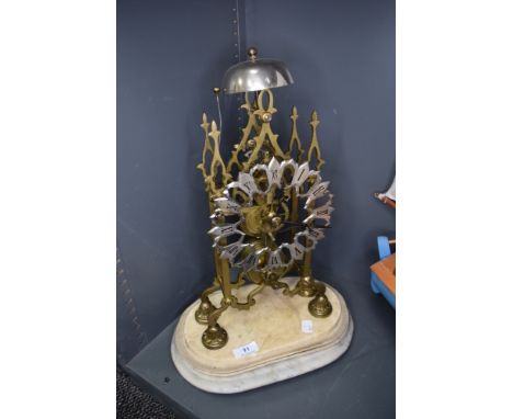 A late Victorian Skeleton clock having brass mechanism with chime on marble base