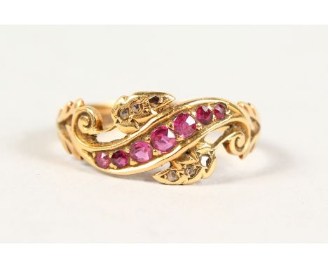 AN 18CT GOLD, DIAMOND AND RUBY CROSSOVER RING.