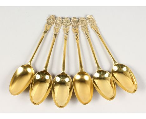 A COMPOSITE SET OF SIX GEORGIAN SILVER GILT TABLE SPOONS, the finial with a cast mask. London.  Various dates.  Circa. 1750-1