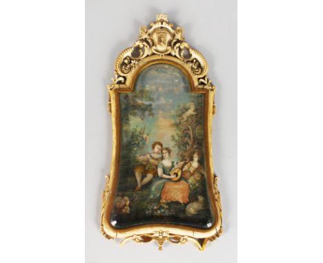 A LATE 18TH CENTURY FRENCH CARVED IVORY FRAMED EASEL PICTURE, the frame with crest and pierced decoration, the painted panel 