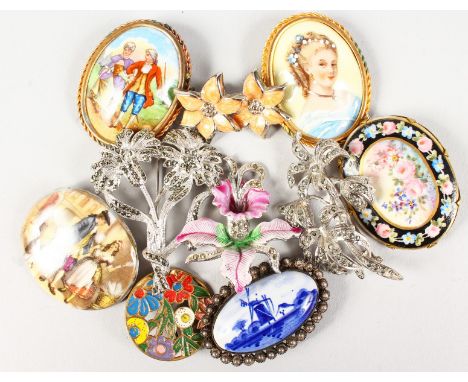 AN ENAMEL CIRCULAR BROOCH, FIVE PORCELAIN BROOCHES, THREE FLOWER BROOCHES AND PAIR OF EAR STUDS.