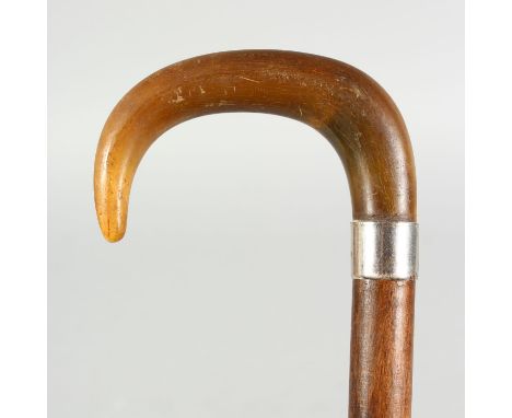 A RHINO HORN HANDLED WALKING STICK, with metal collar.