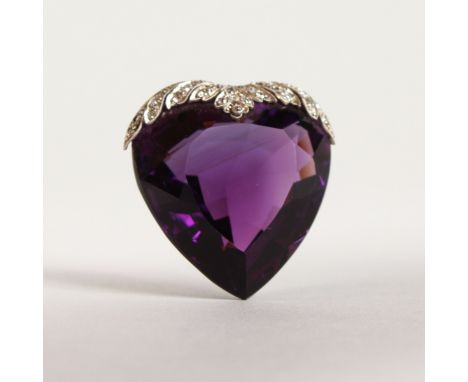 A LARGE HEART SHAPED DIAMOND MOUNTED AMETHYST PENDANT.
