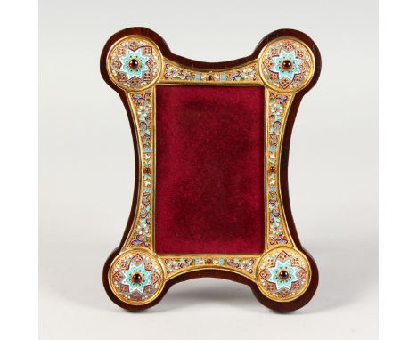 A RUSSIAN SILVER AND CHAMPLEVE ENAMEL SHAPED PHOTOGRAPH FRAME. 9.5ins x 7ins.