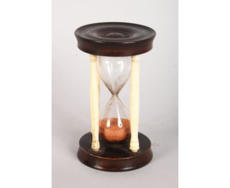 AN IVORY AND WOODEN EGG TIMER. 3.25ins high.