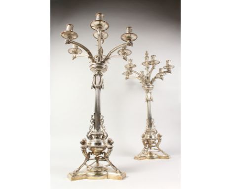 A SUPERB LARGE PAIR OF VICTORIAN SILVER SIX BRANCH CANDELABRA, with central candle sconce, 31ins high, the centre column supp