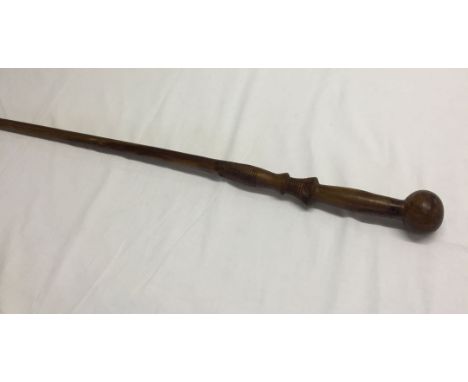 A carved light wood walking stick.