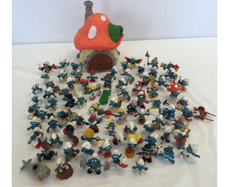 A box of 79 Esso blue Smurf figures 1978-1983 together with a Smurf mushroom house.