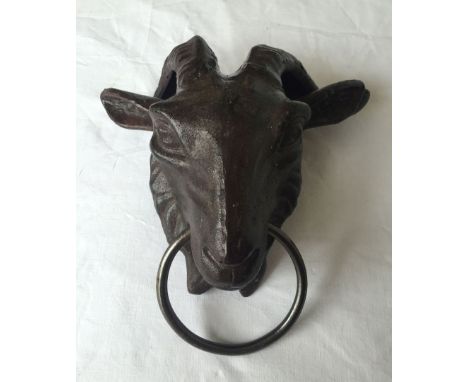 A modern cast iron rams head door knocker.
