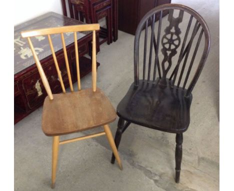 An Ercol blonde chair with a dark wood wheel back chair.