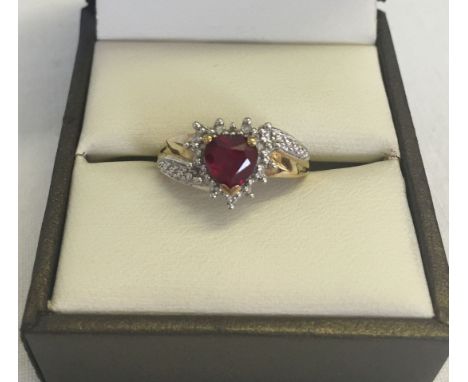 A 9ct gold created ruby and diamond dress ring in a heart shap. Size L total weight 2.1g.