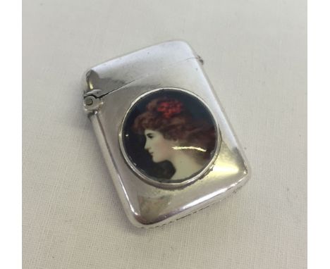 A silver vesta case. Hallmarked Birmingham 1902 with front panel depicting a portrait of a young lady.