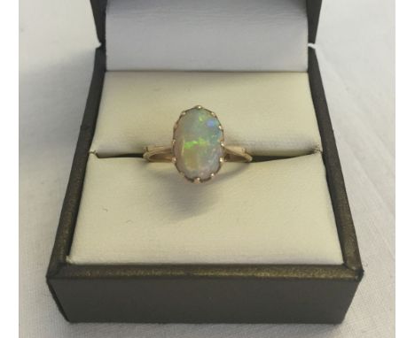 A 9ct gold & opal ring. Set with an oval opal. Size K. Total approx weight 2.3g.