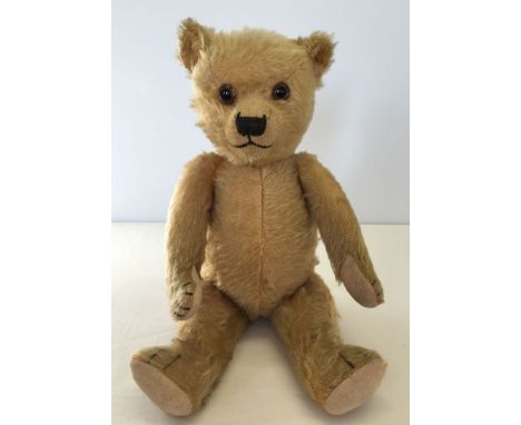 c1930s blonde mohair teddy bear believed to be by Chiltern. Approx 17" tall, fully jointed., glass eyes, stitched nose with t