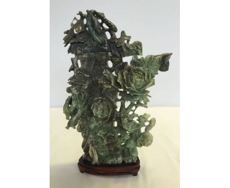 A large jade carving of a column with entwined flowers, gourds, birds & animals. 31.5cm tall (exc wooden base)