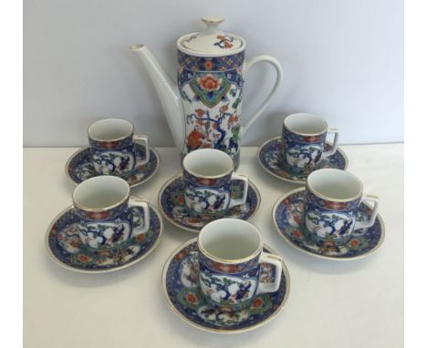 An oriental style coffee set of blue and white colouration. Comprising 6 cup and saucers and a coffee pot.