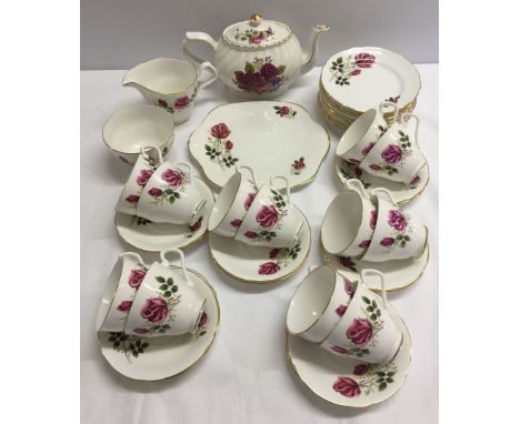 A Royal Windsor Rose pattern tea set comprising 12 side plates, a sandwich plate, 12 cups and saucers, sugar bowl and milk ju