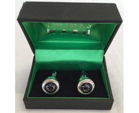 A boxed pair of Thomas Nash working compass cufflinks.